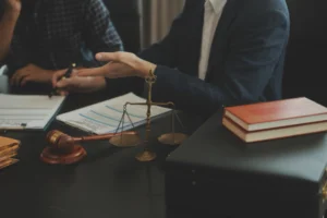 A solicitor discusses the process for train accident claims while sat a desk with a client who wants to claim compensation