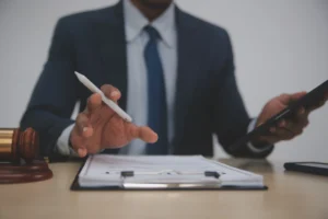 A solicitor works on a No Win No Fee garden accident claim at a desk.