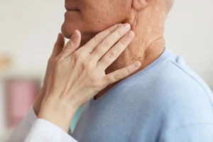 A doctor examining an elderly patient as part of the assessment for a medical negligence compensation claim